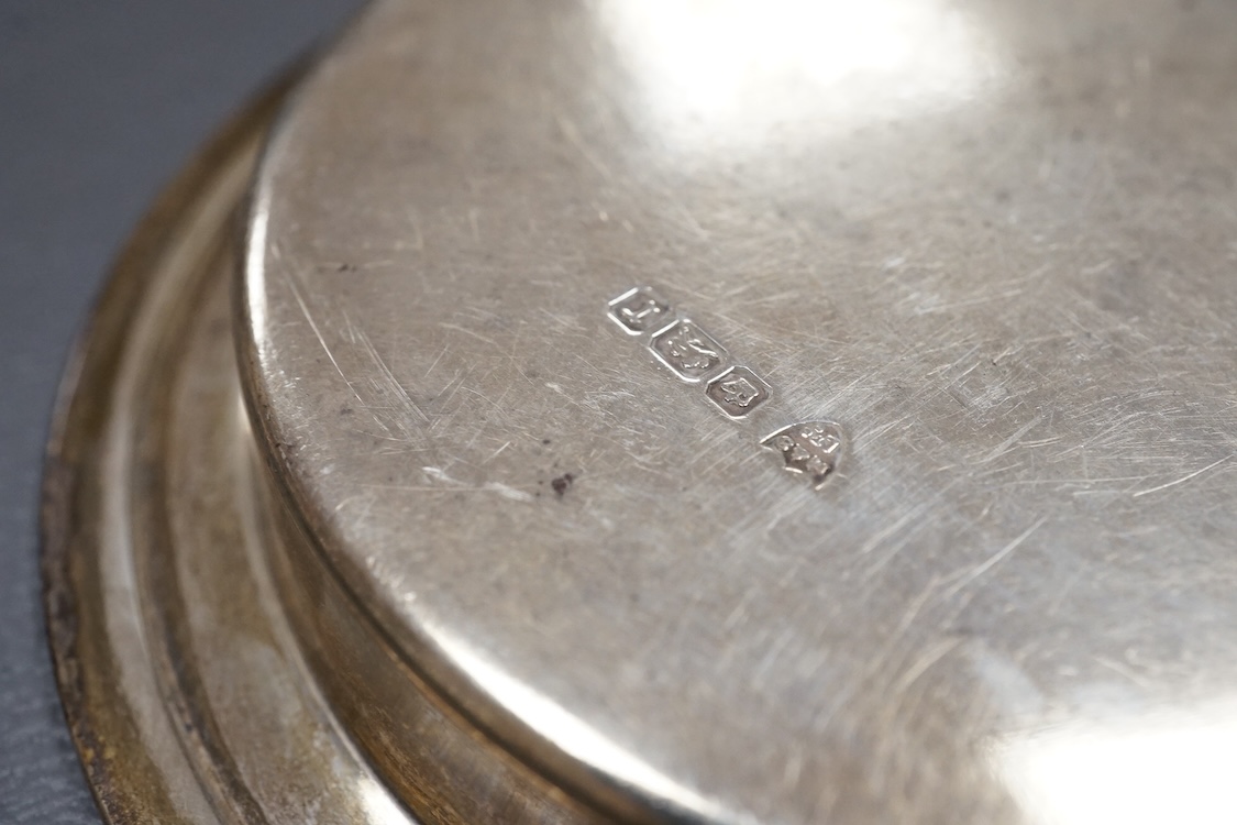 A 1940's silver mounted cigarette box, two small silver dishes, a silver mounted desk calendar, a silver mounted photograph frame and a continental silver bonbon dish modelled as a boat, import marks for John George Pidd